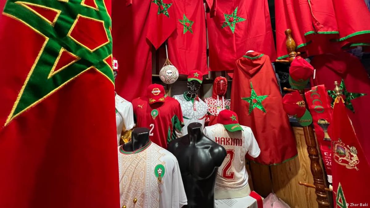 Morocco national soccer team fans celebrating during match, showing pride in nation's progress