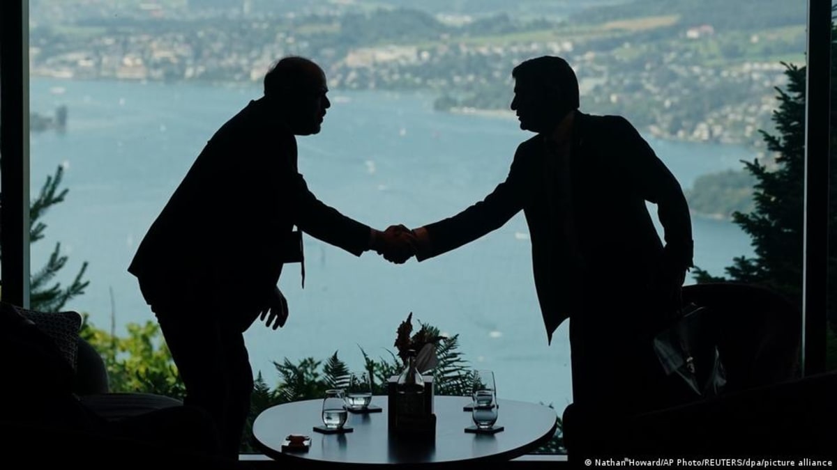 ** US and Iranian flags side by side representing diplomatic negotiations and progress toward peace