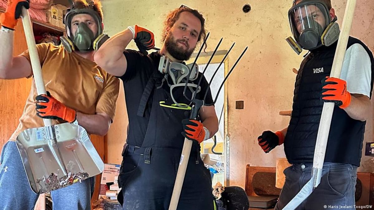 Volunteers helping clean and organize a cluttered room for someone with hoarding disorder