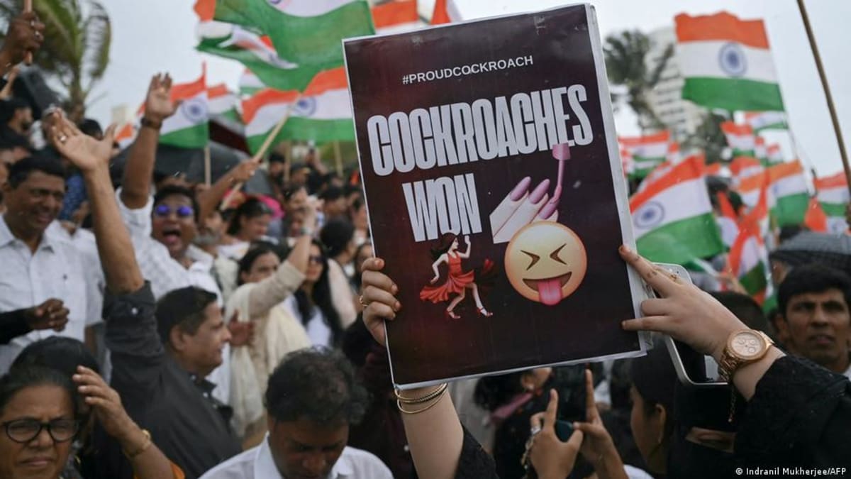 ** Young student protesters celebrating with raised arms at New Delhi protest site