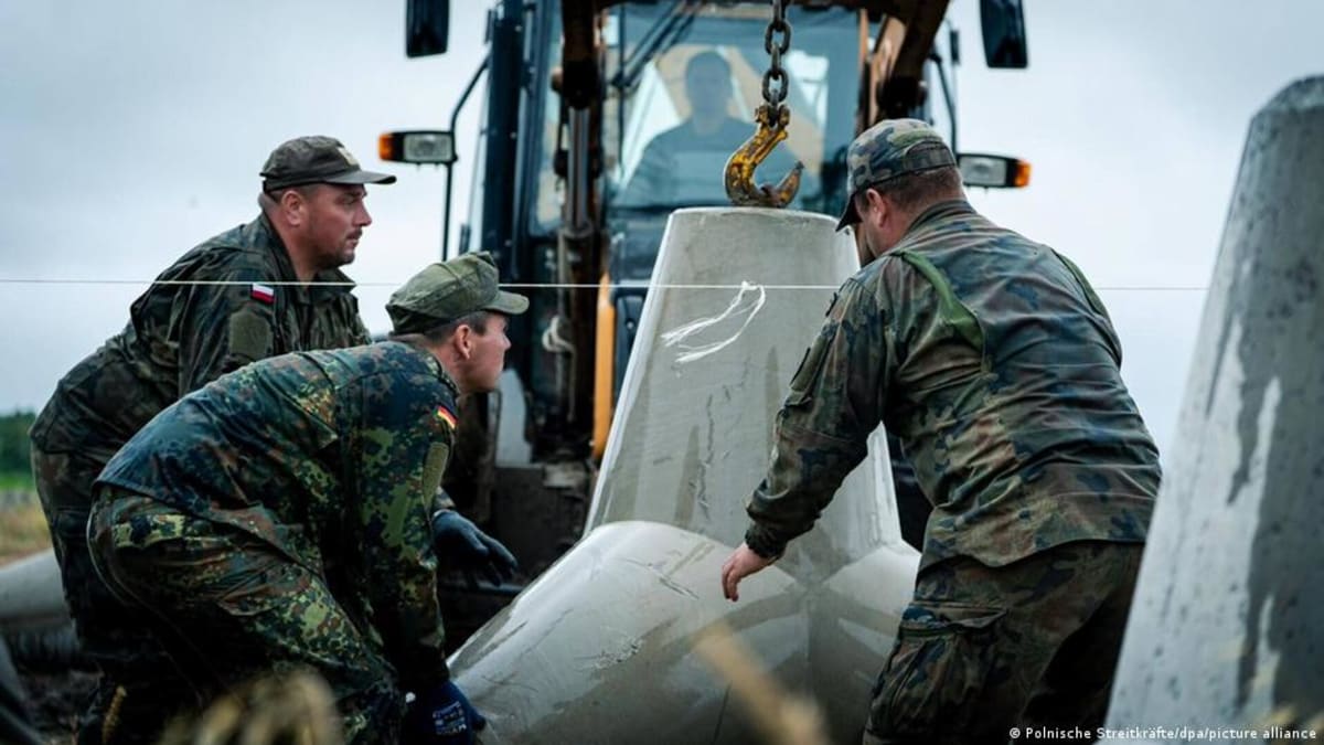 German and Polish soldiers installing concrete anti-tank obstacles near the Polish-Russian border