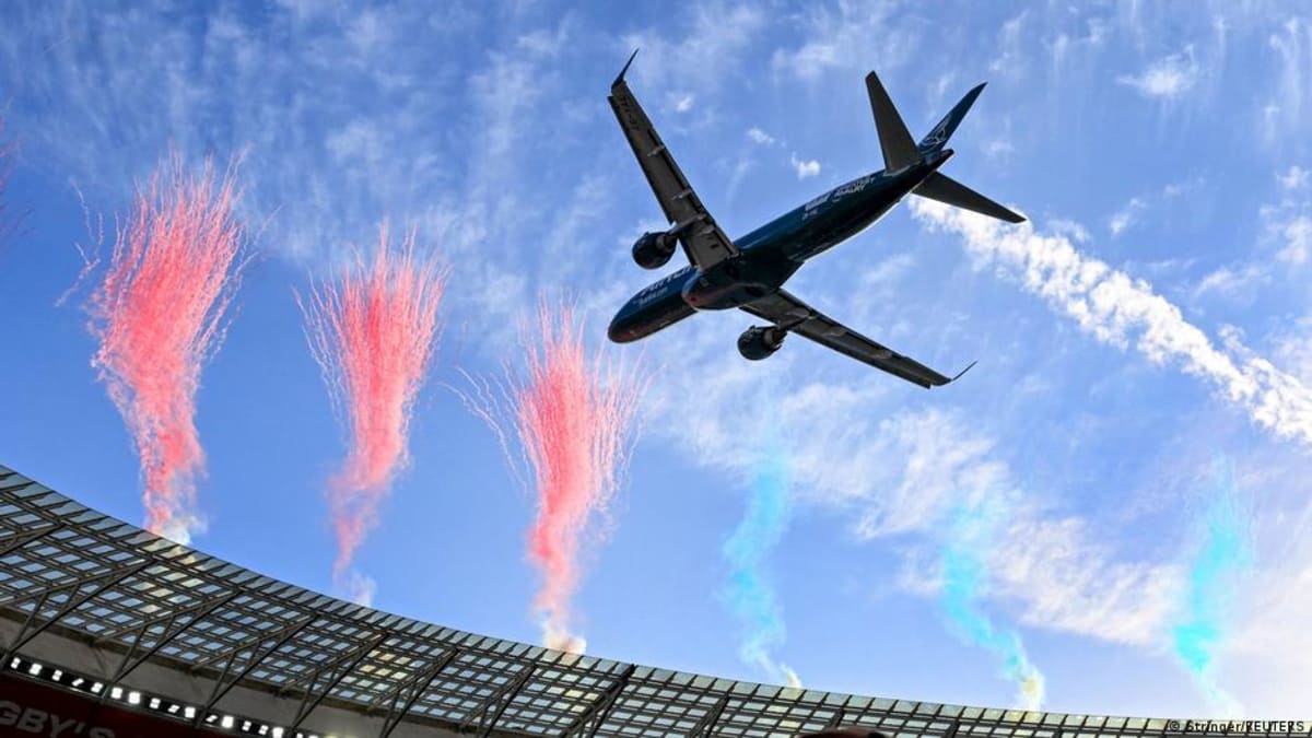 Two passenger jets flying in formation above packed rugby stadium in Cape Town