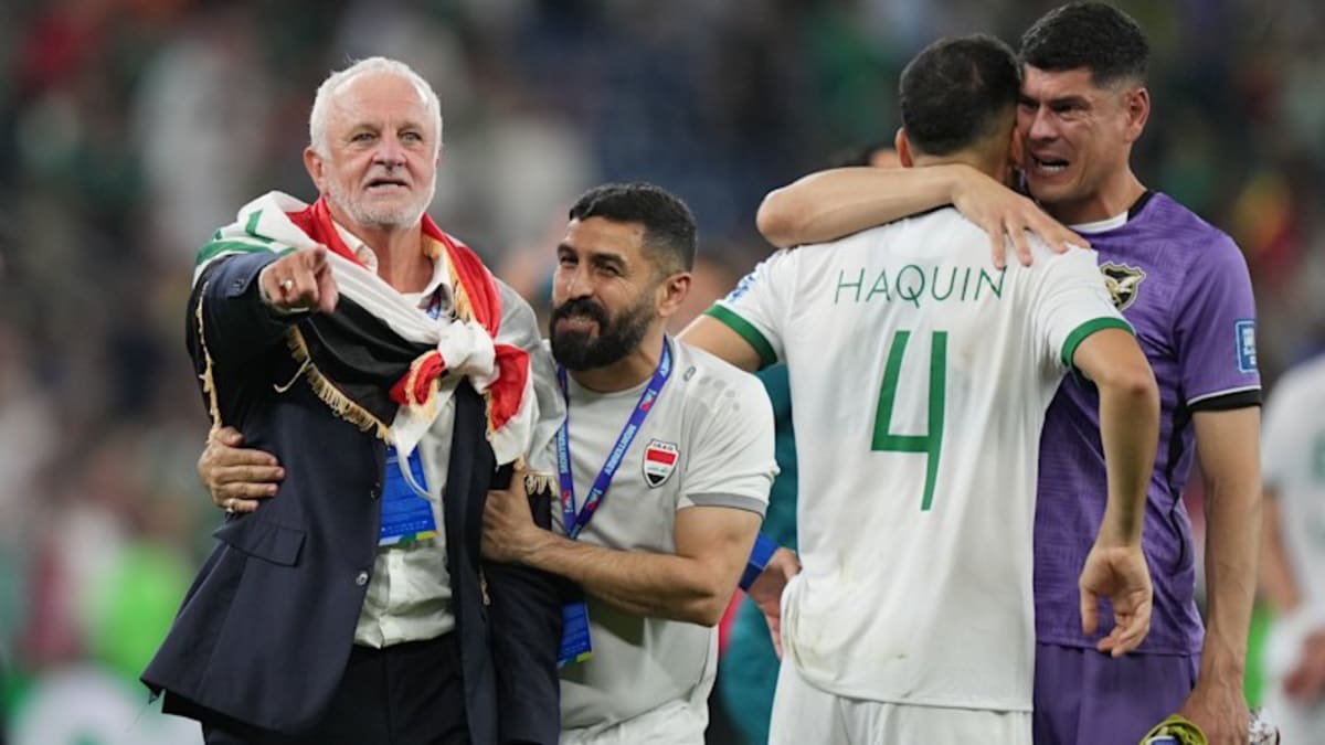 Graham Arnold celebrating with Iraqi flag after historic World Cup qualification victory