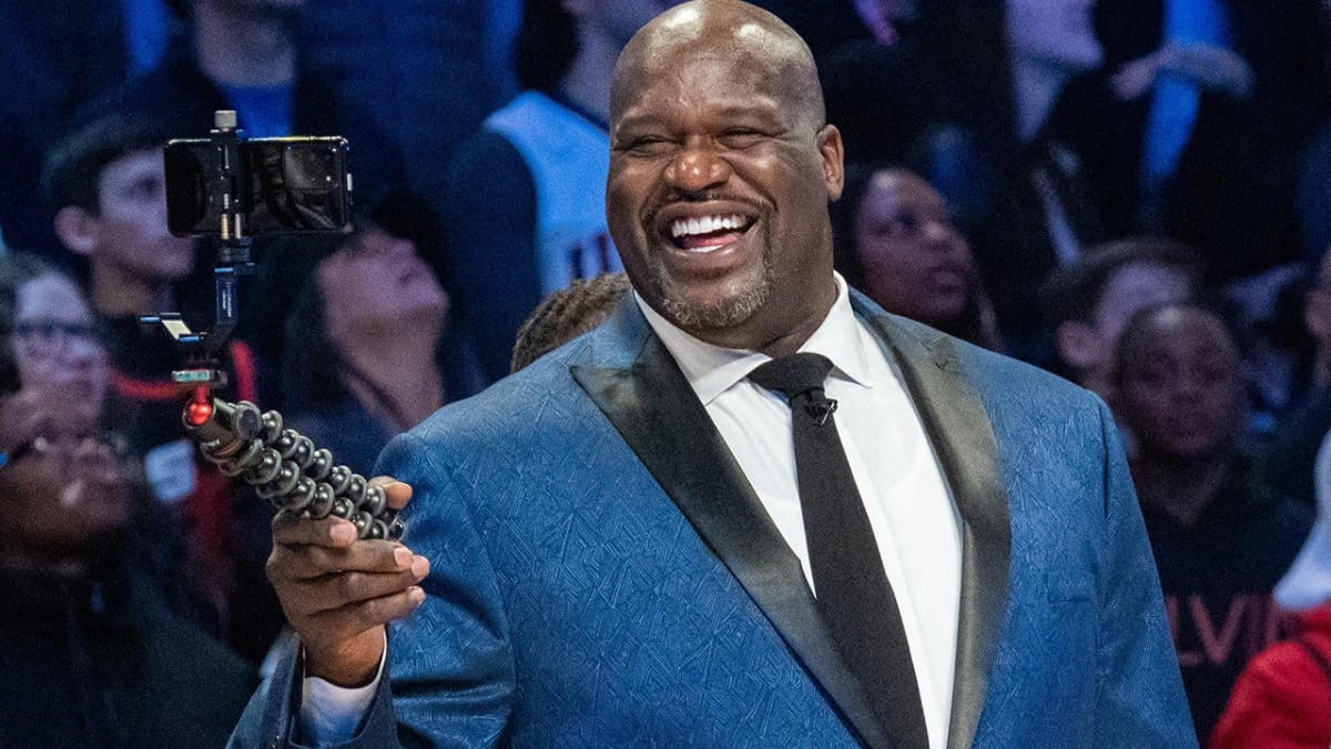 Shaquille O'Neal in graduation cap and gown celebrating his master's degree from LSU