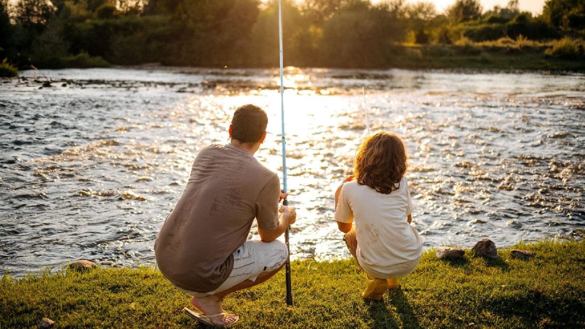Father and child sitting together at school table during All Pro Dad chapter meeting