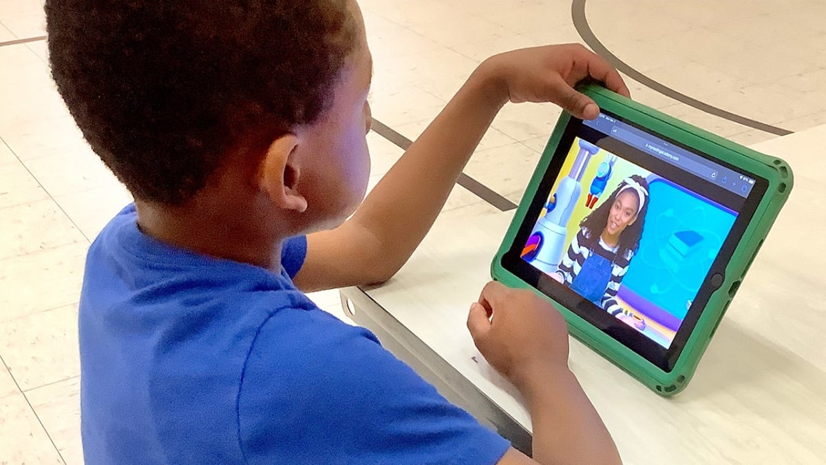 Students working with AI technology in modern classical education classroom setting