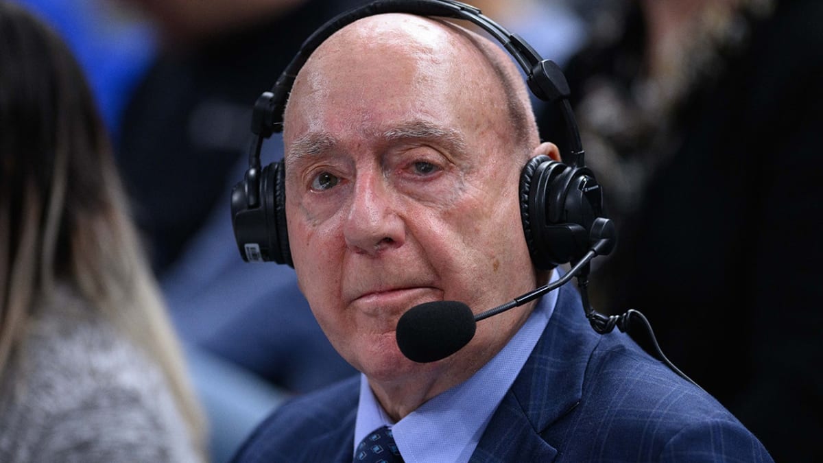 Legendary ESPN broadcaster Dick Vitale smiling on the sidelines at a college basketball game