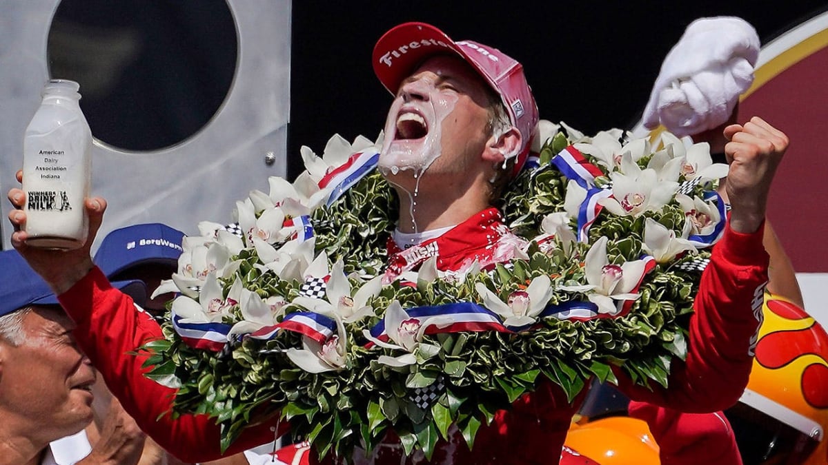IndyCar driver Marcus Ericsson celebrating victory at Indianapolis Motor Speedway in racing suit