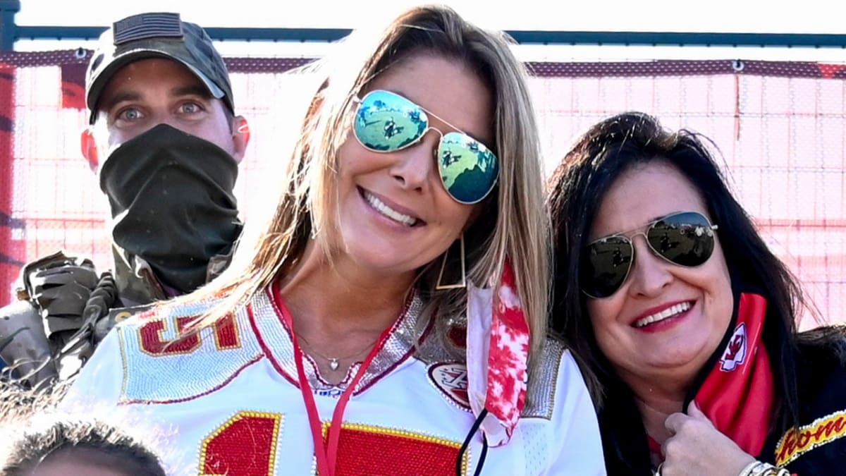 Randi Mahomes smiling with family members at Kansas City Chiefs football game