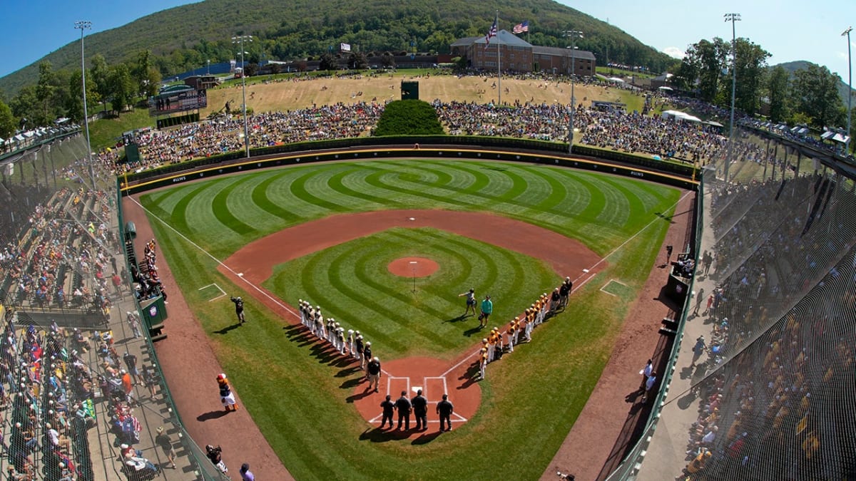 Young baseball players on field during Little League tournament game competition
