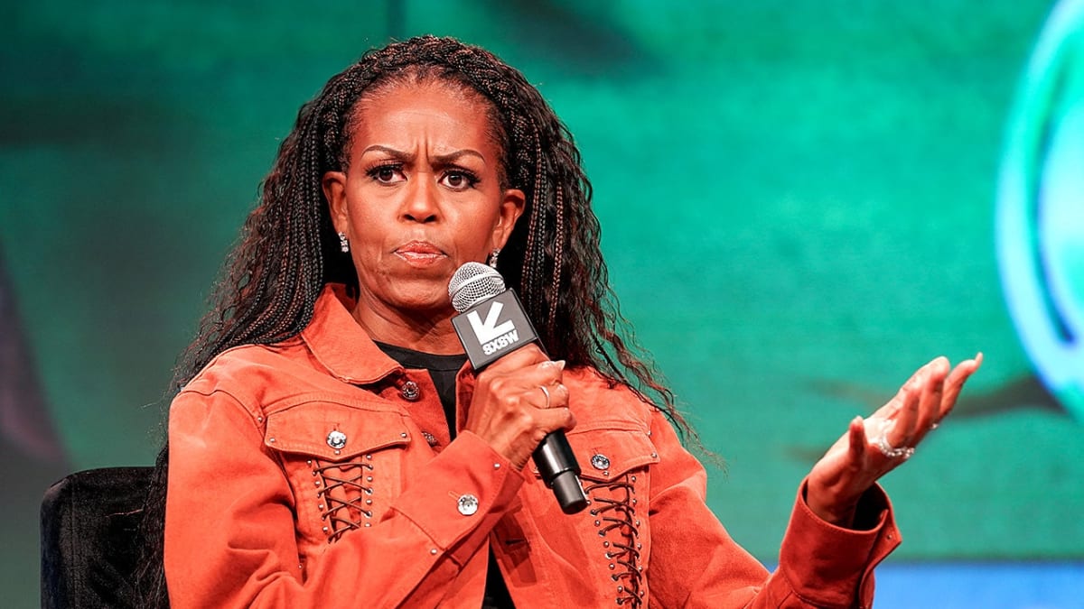 Michelle Obama speaking during a live recording of her podcast IMO