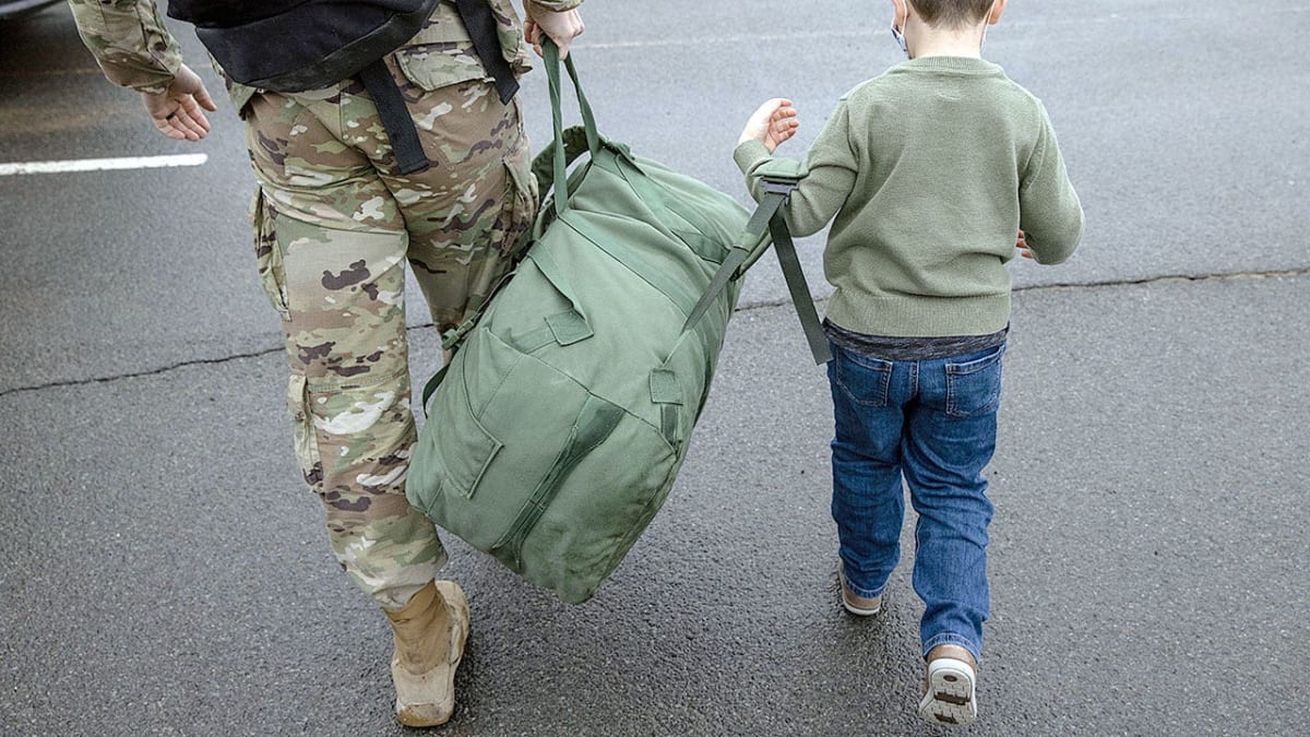 Veteran caregiver assisting service member at home, representing millions of military families awaiting Congressional support