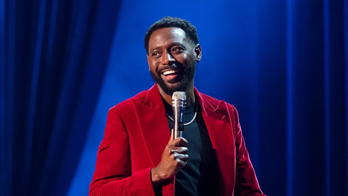 Comedian Kountry Wayne smiling with his 10 children at an Atlanta event premiere