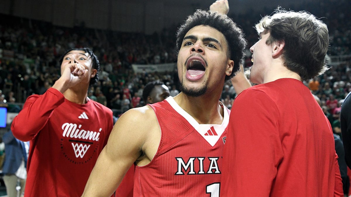Miami RedHawks players celebrating on court after overtime victory securing undefeated season