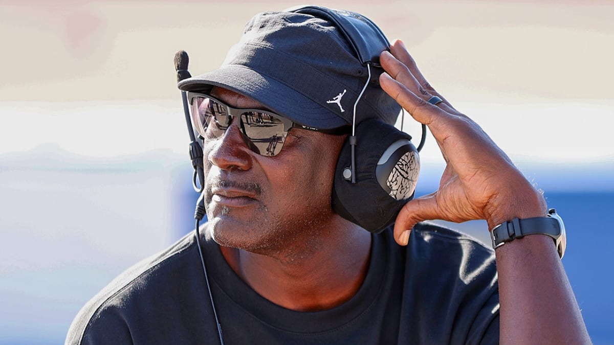 Michael Jordan celebrating with his 23XI Racing team in NASCAR pit lane after victory