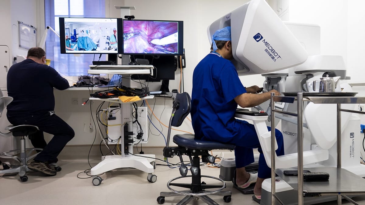 Surgeon at robotic control console performing remote surgery procedure across international borders