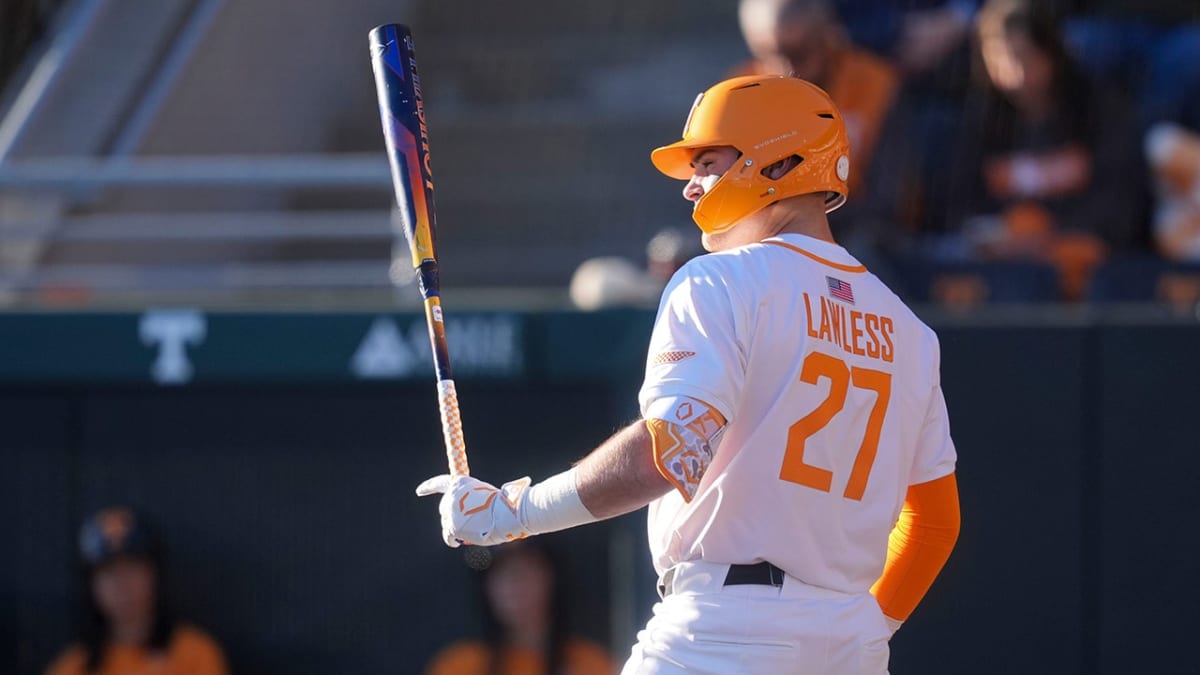 Georgia outfielder Cole Johnson leaping at wall to catch baseball during game against Tennessee