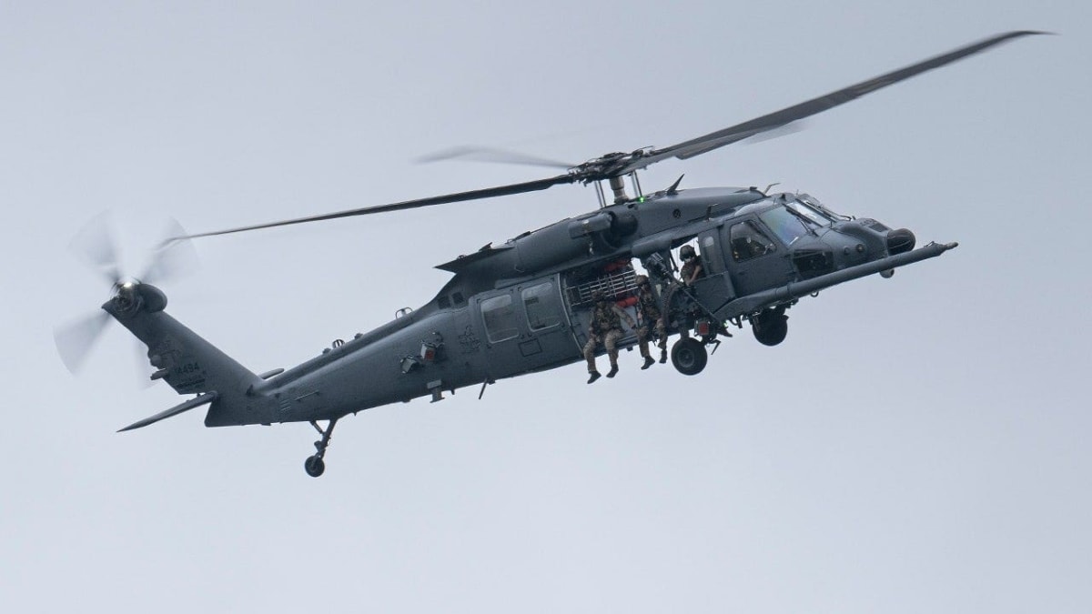 Military helicopter flying over mountainous terrain during rescue operation in southwestern Iran