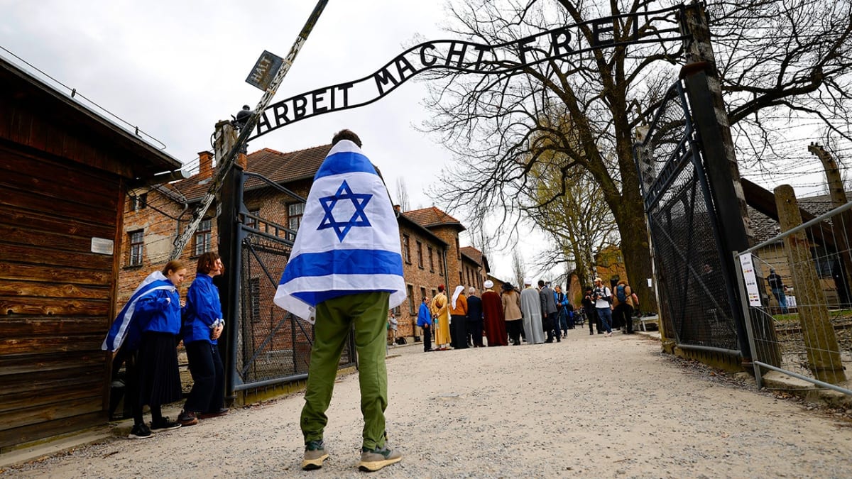International police delegation marching together at Auschwitz-Birkenau memorial site in Poland