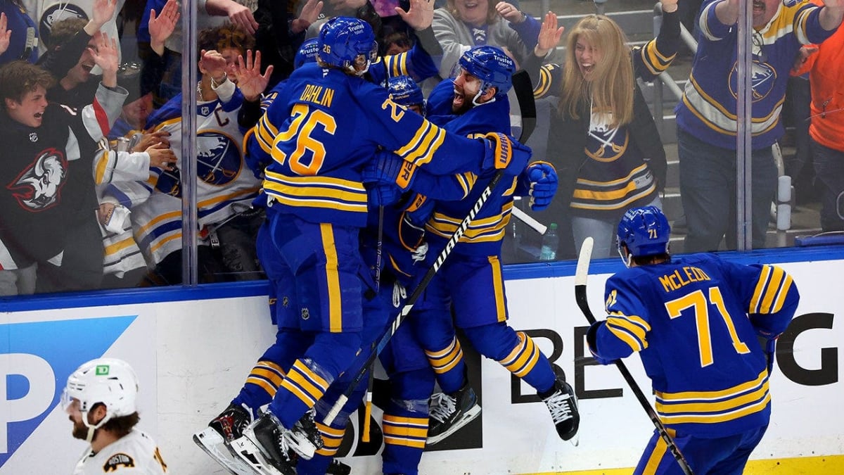 Buffalo Sabres players celebrate on ice during historic playoff comeback victory over Boston Bruins