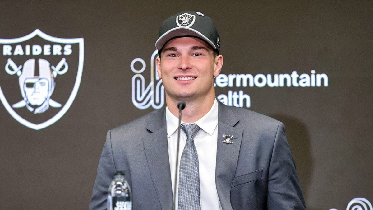 Raiders quarterback Fernando Mendoza saluting the camera during an ESPN sideline interview