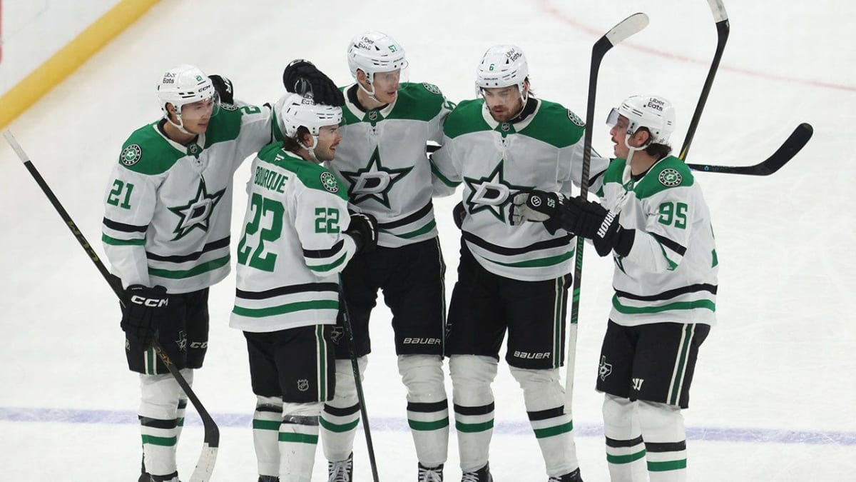 Dallas Stars players celebrating on ice at American Airlines Center hockey arena