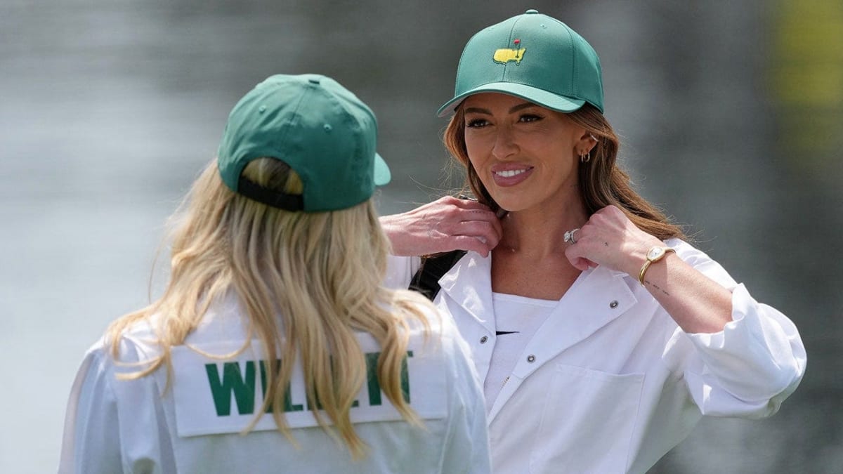 Paulina Gretzky caddies for Dustin Johnson during Masters Par 3 Contest at Augusta National