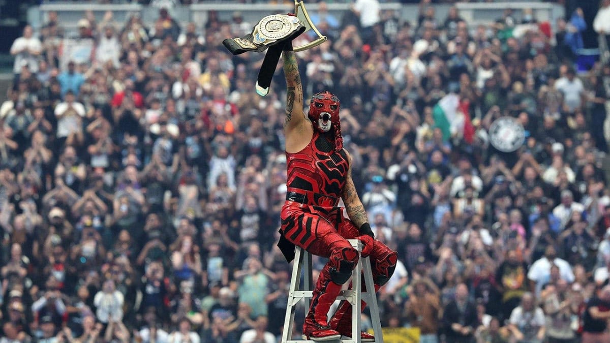 Penta celebrates holding the Intercontinental Championship belt above his head after winning ladder match