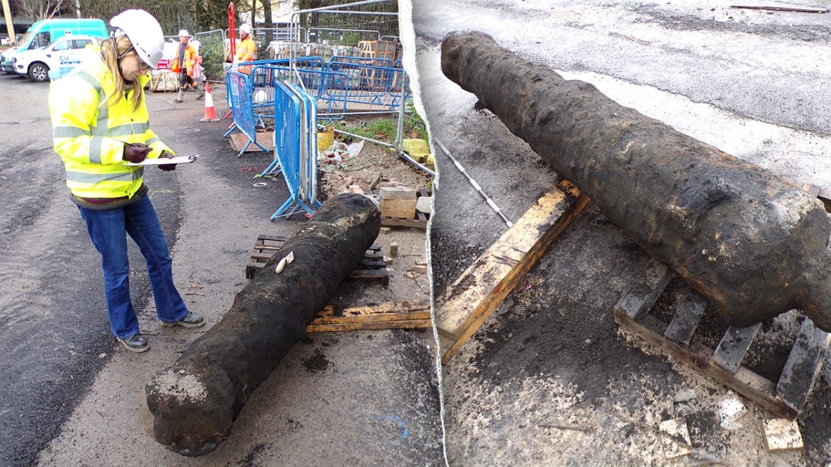 Heavily corroded nine-foot iron cannon from 1700s lying on ground after excavation in Hull