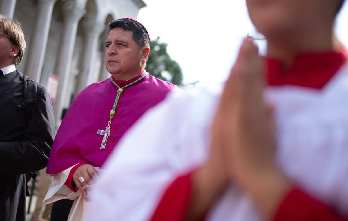 Bishop Evelio Menjivar-Ayala in ceremonial robes leading religious procession in Washington