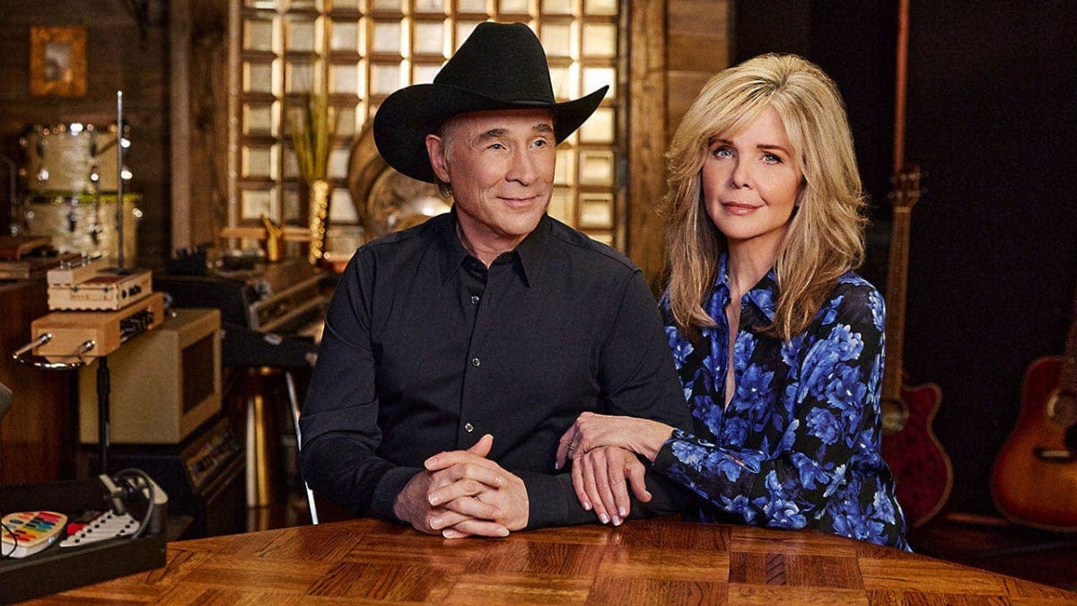 Clint Black and Lisa Hartman Black smiling together at a public event