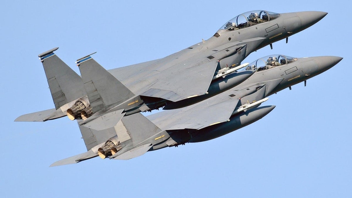 Military fighter jets flying in formation through clouds during rescue operation