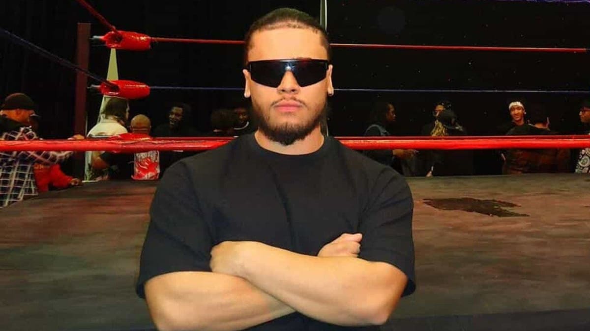 Pro wrestler Dono Hefner performing an athletic move in the wrestling ring