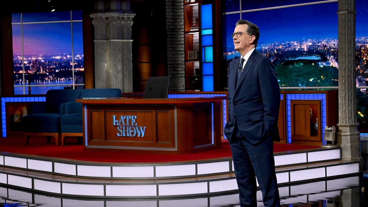 ** Stephen Colbert standing on stage with family and Late Show staff during emotional series finale