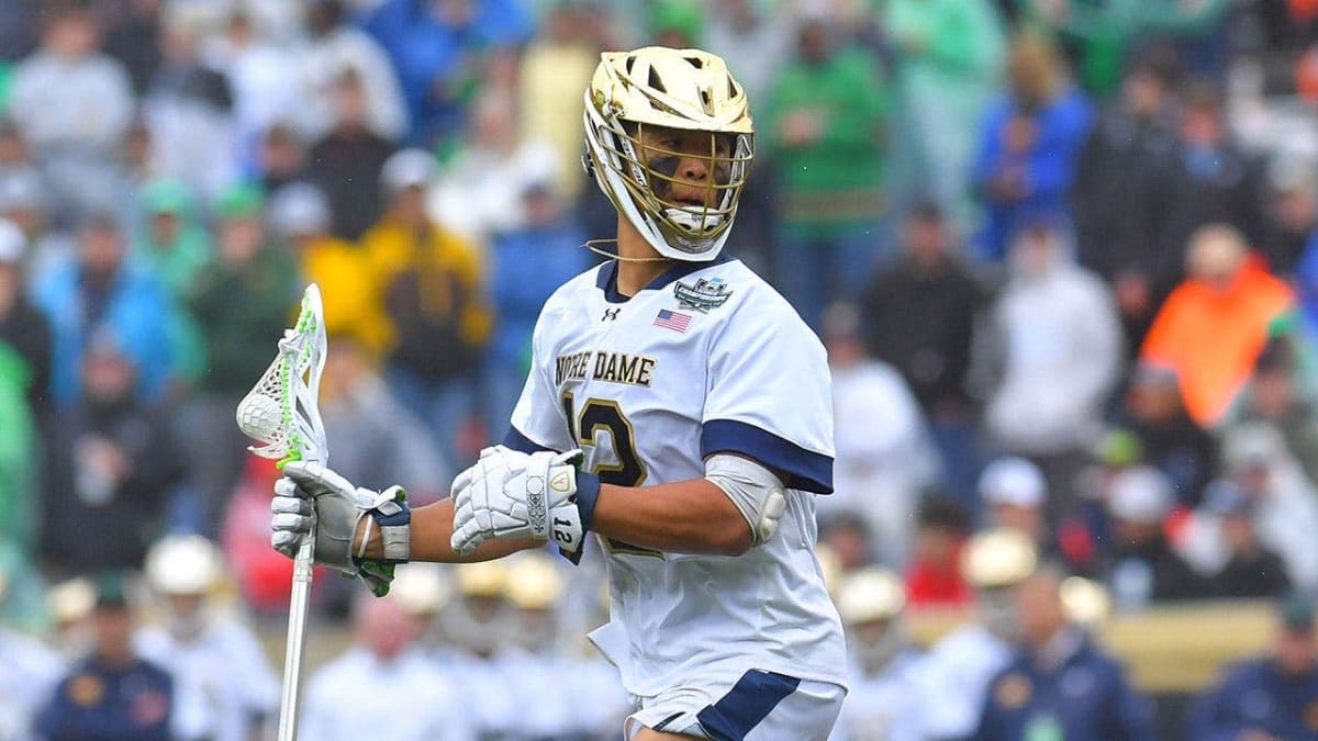 Josh Yago in Notre Dame lacrosse uniform saluting during national anthem at championship game