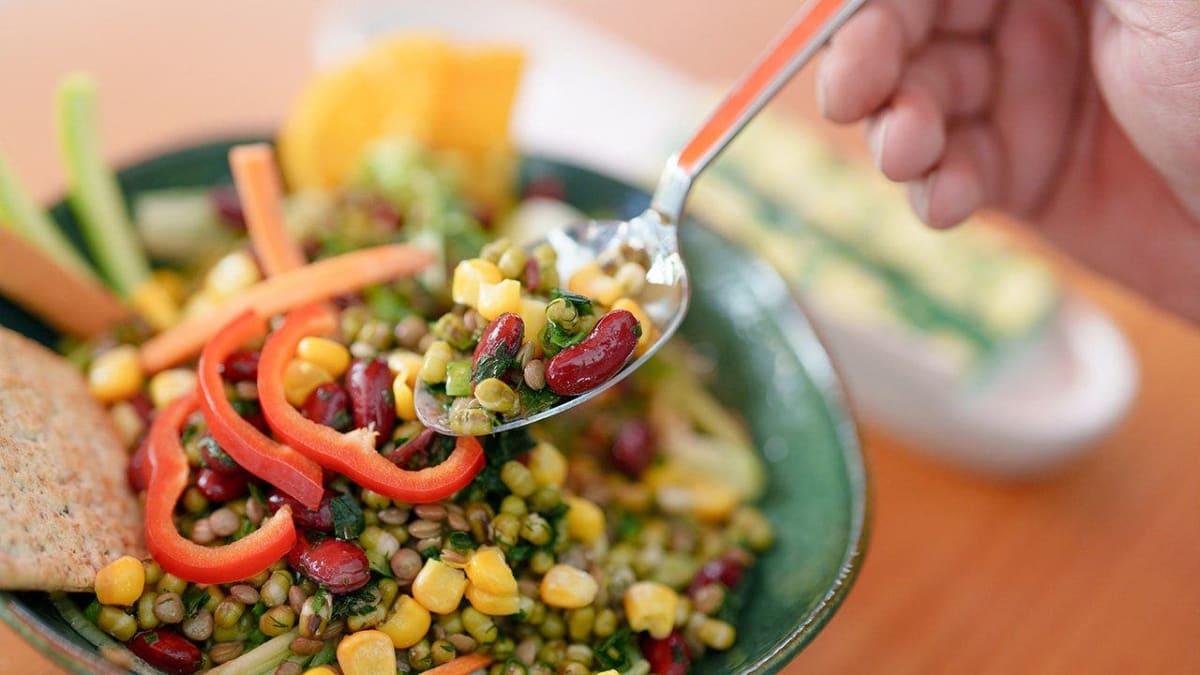 Older adults enjoying colorful plant-based meal with vegetables and whole grains together