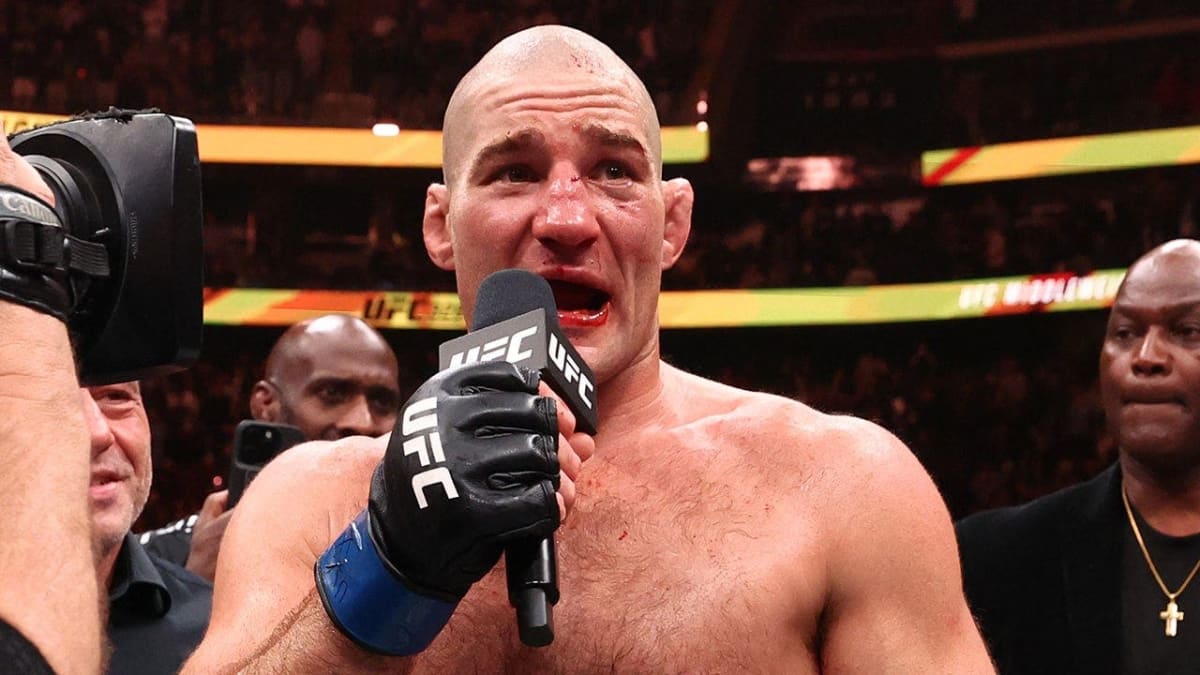 Sean Strickland celebrates with championship belt raised after winning UFC middleweight title
