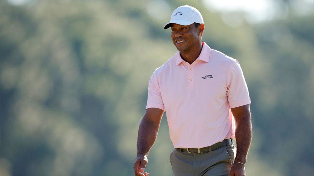 Tiger Woods watching golf during tournament wearing cap and dark clothing