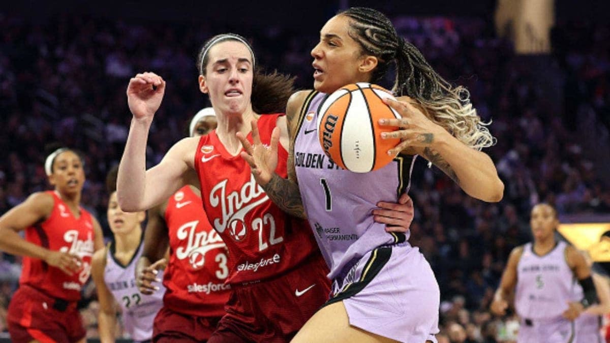 Caitlin Clark dribbling basketball during WNBA game in Indiana Fever uniform