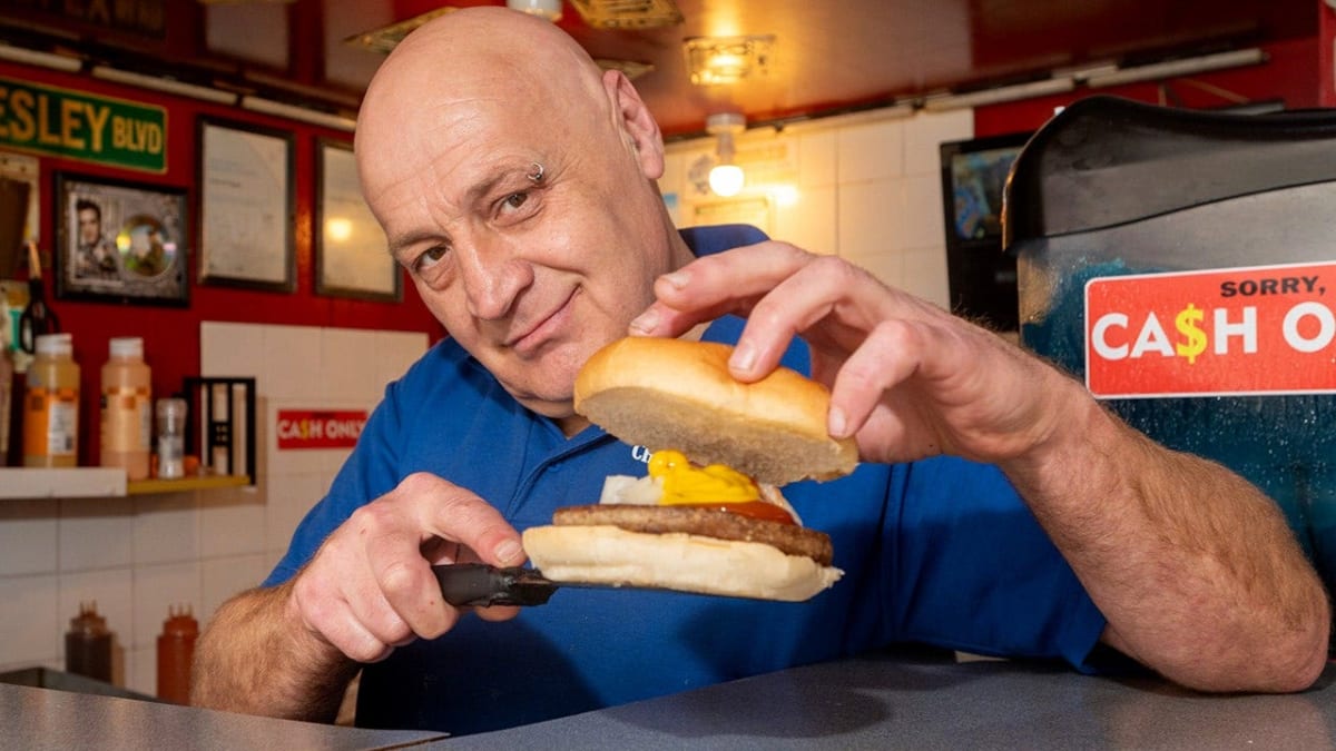 Chris Higgitt preparing burgers at his seaside stand in Blackpool, England