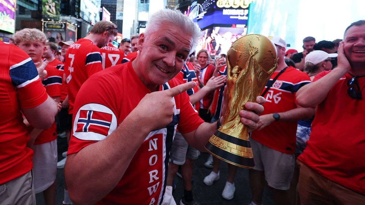 Norwegian soccer fans in red jerseys performing synchronized Viking Row chant in crowded Times Square