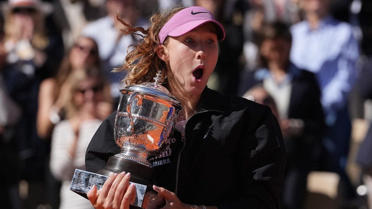 Russian tennis player Mirra Andreeva holds Suzanne-Lenglen Trophy high above head celebrating French Open victory