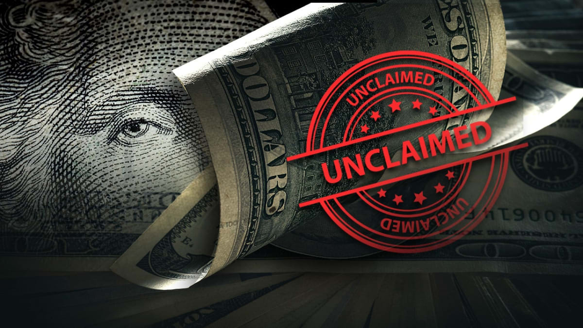 Person searching online database on laptop discovering unclaimed money in their name