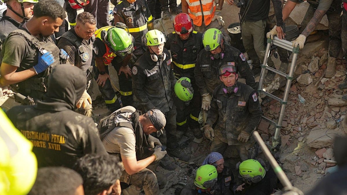 International rescue workers carefully searching through earthquake rubble in Venezuela to find survivors
