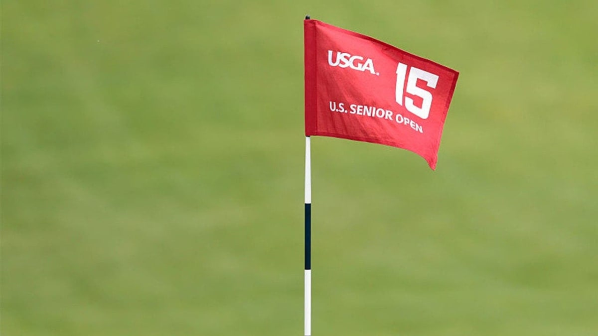 Golf course fairway with flagstick on green during amateur tournament qualifying round