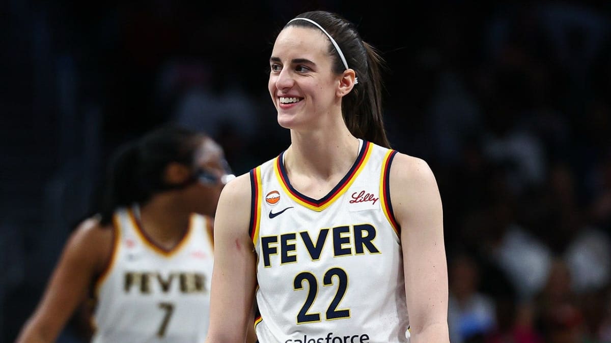 Caitlin Clark, Aliyah Boston, and Kelsey Mitchell celebrating together on basketball court in Indiana Fever uniforms