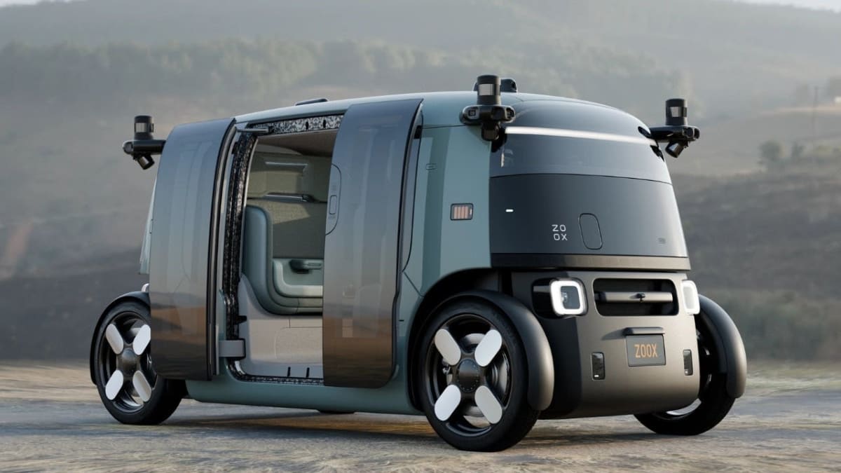 Futuristic Zoox robotaxi interior with aloe-green seats facing each other and stone-grey trim