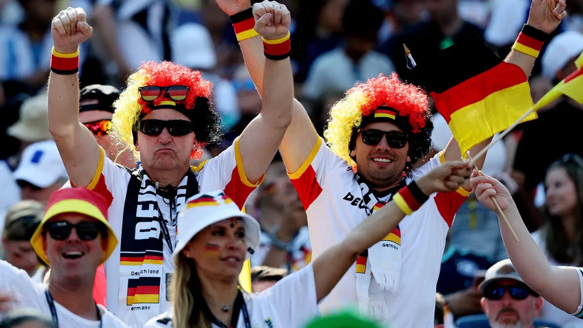 German soccer fans cheering enthusiastically at 2026 FIFA World Cup match in stadium