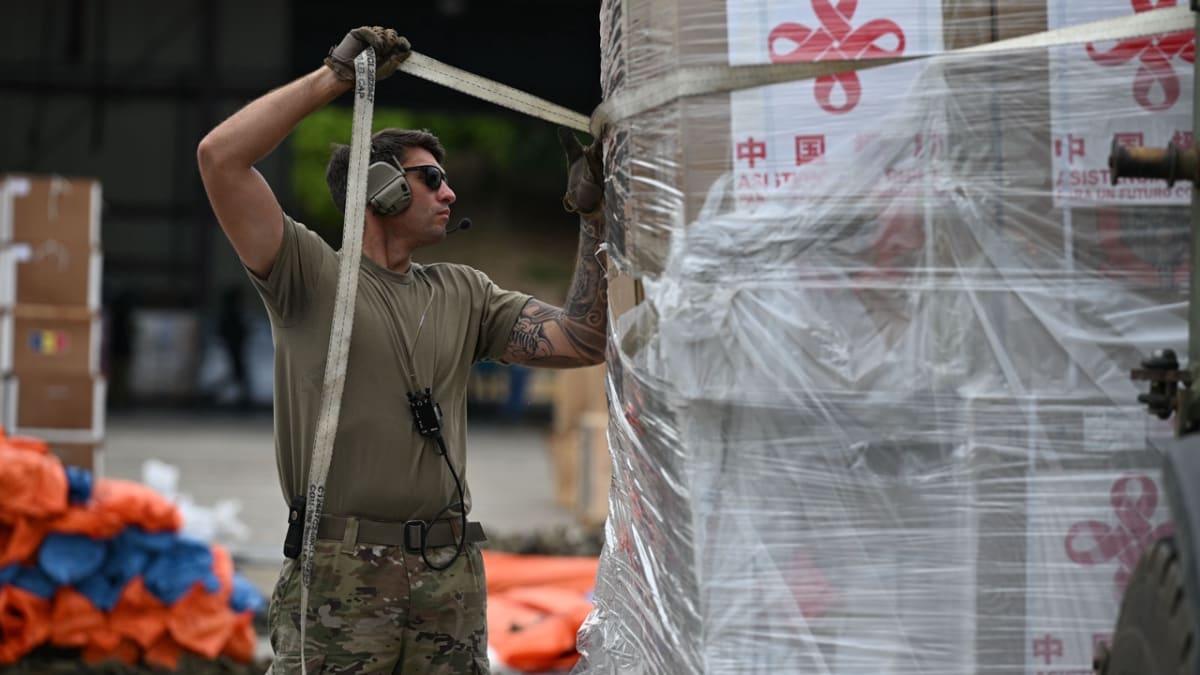 U.S. soldiers unload humanitarian supplies from cargo plane on airport tarmac in Venezuela