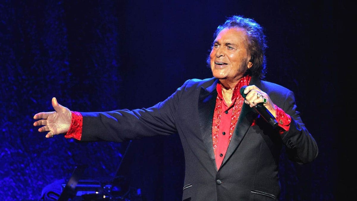Engelbert Humperdinck performing on stage in formal attire with microphone